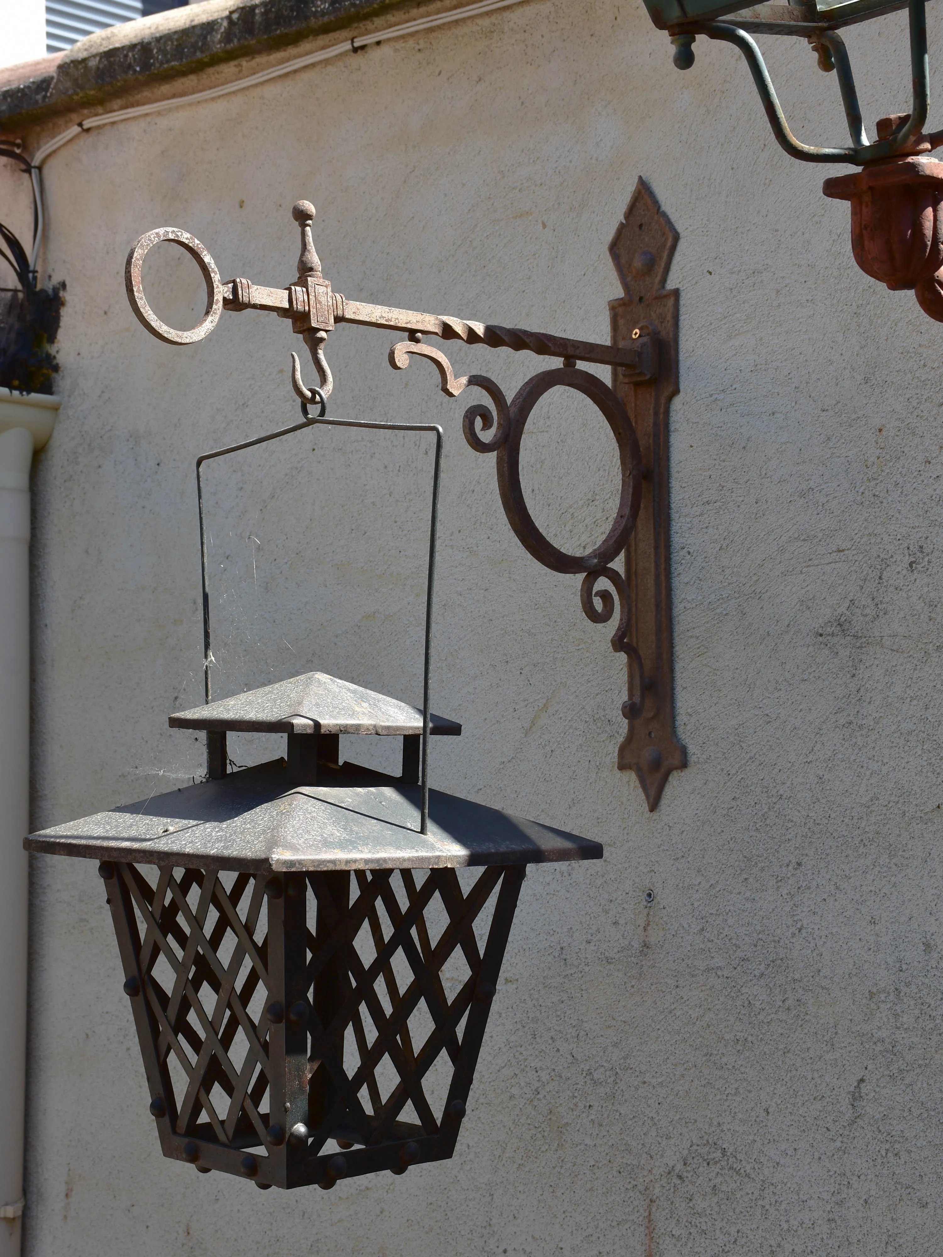 Pair of French wrought iron lanterns with wall brackets